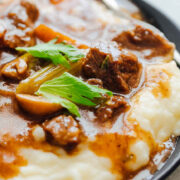 Easy Instant Pot Beef Stew served with mashed potatoes.