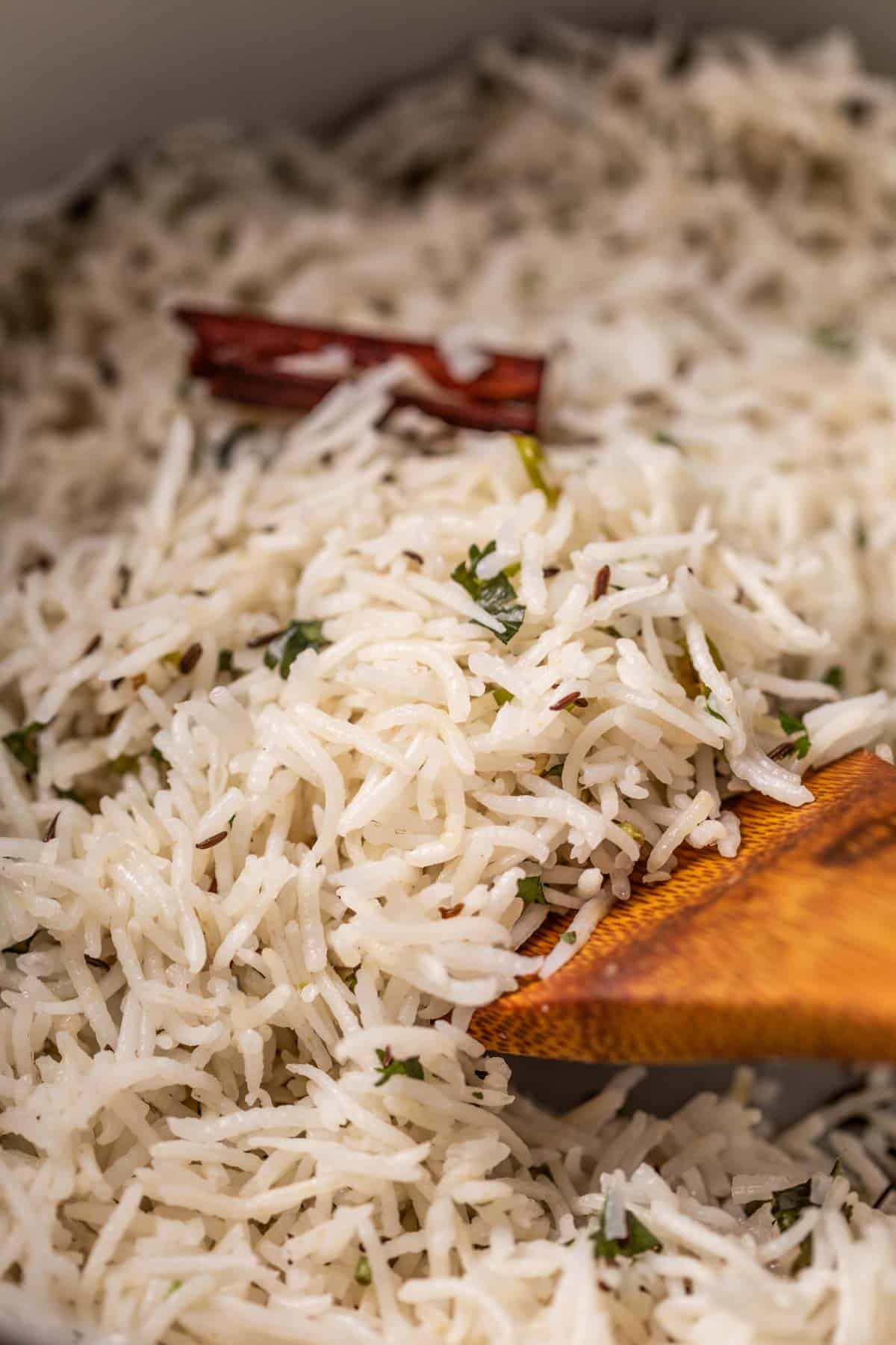 a close up image of jeera rice to show it's fluffy texture