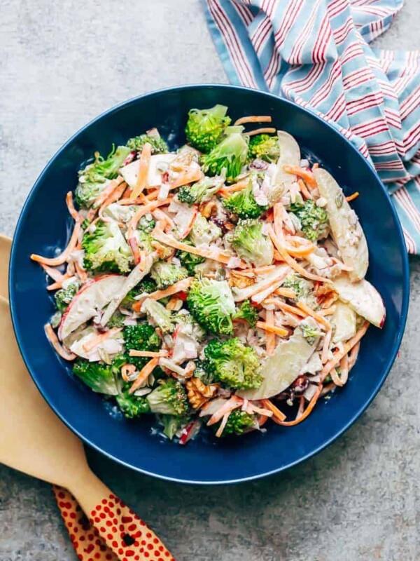 Creamy apple broccoli walnut salad served in a blue bowl