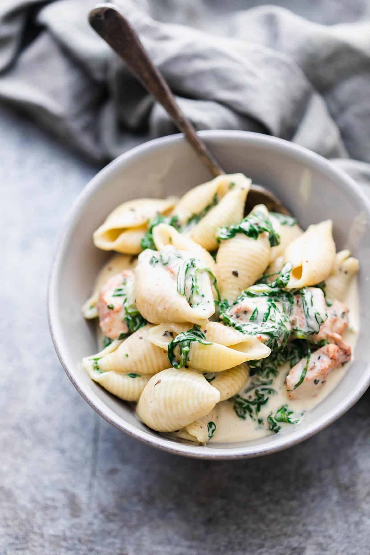 Creamy chicken florentine pasta served in a grey bowl