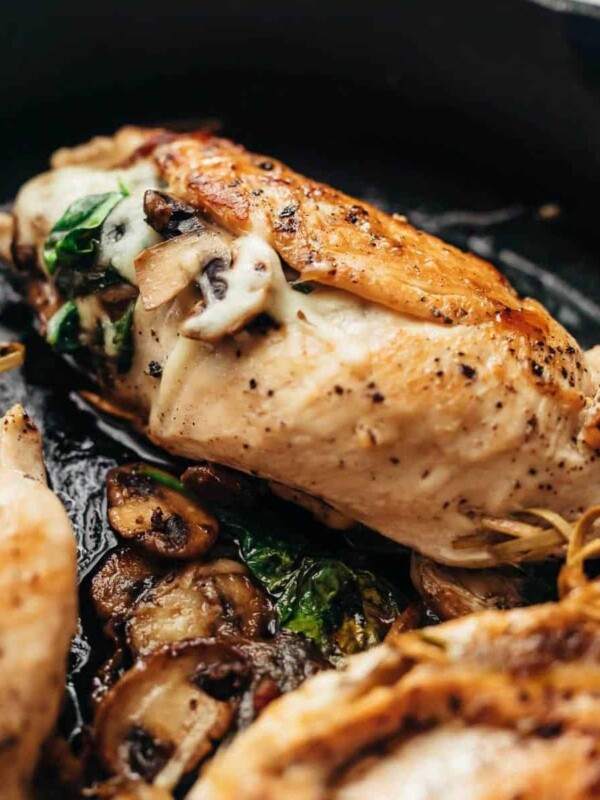 Spinach Mushroom stuffed Chicken Breast cooked in a cast iron pan.