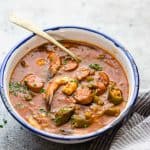 New Orleans Shrimp Sausage Gumbo served in an enamel bowl with a spoon