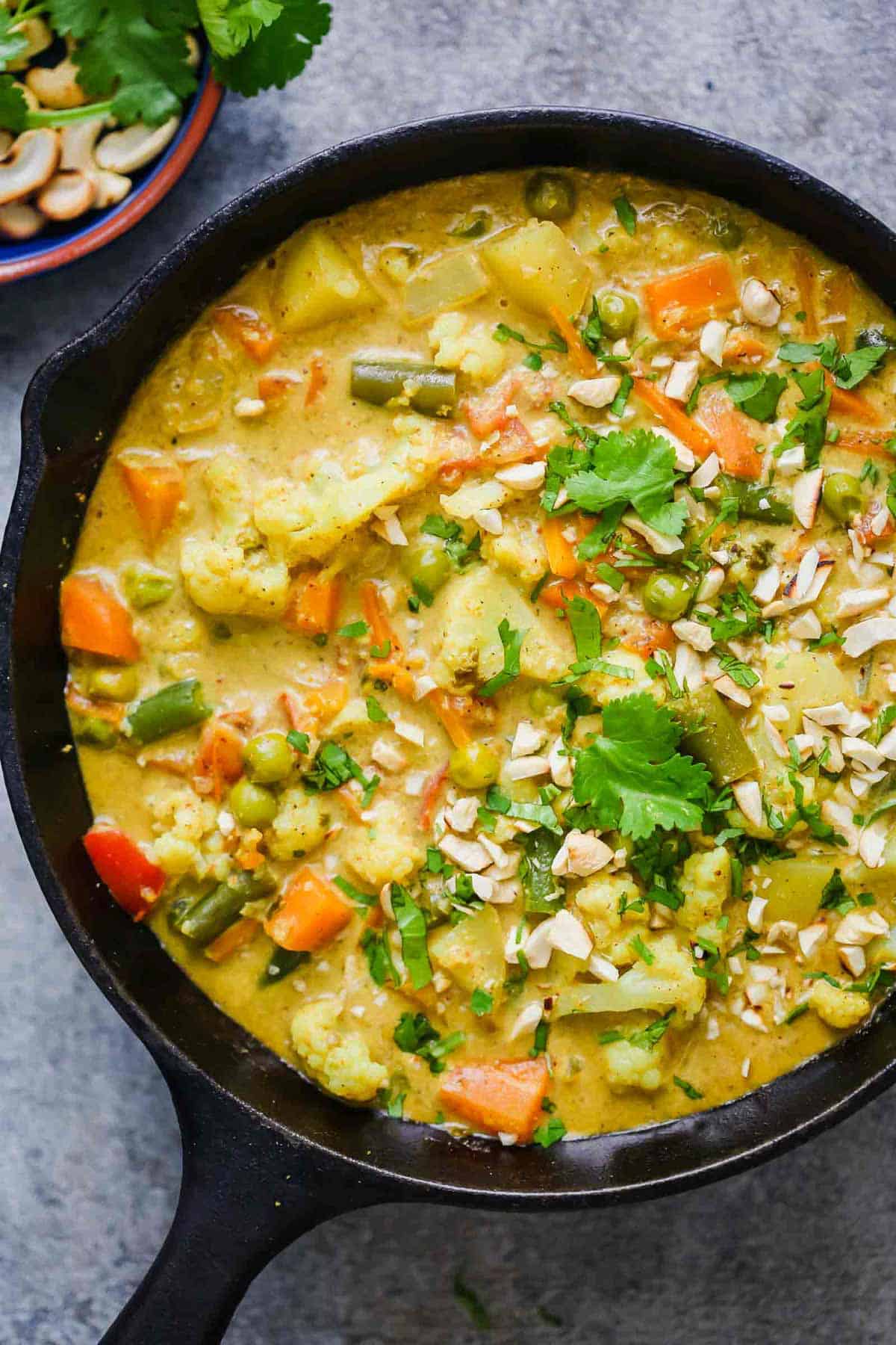 Vegetable Korma Curry straight from the stove served in a cast iron pan