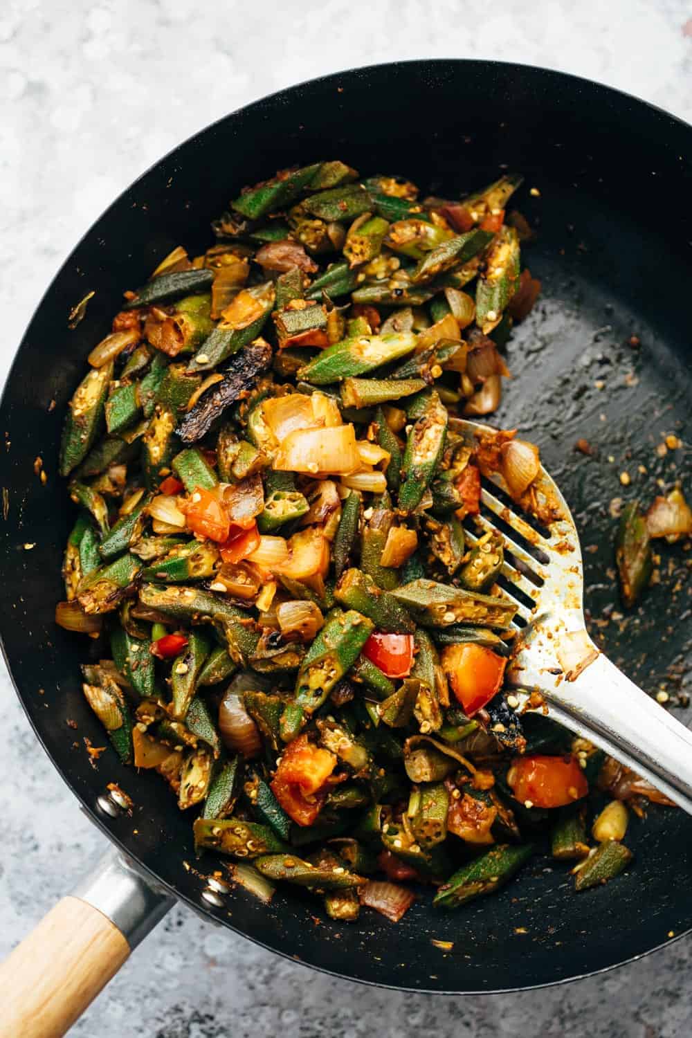 Overhead shot of bhindi masala fry in wok straight from the stove