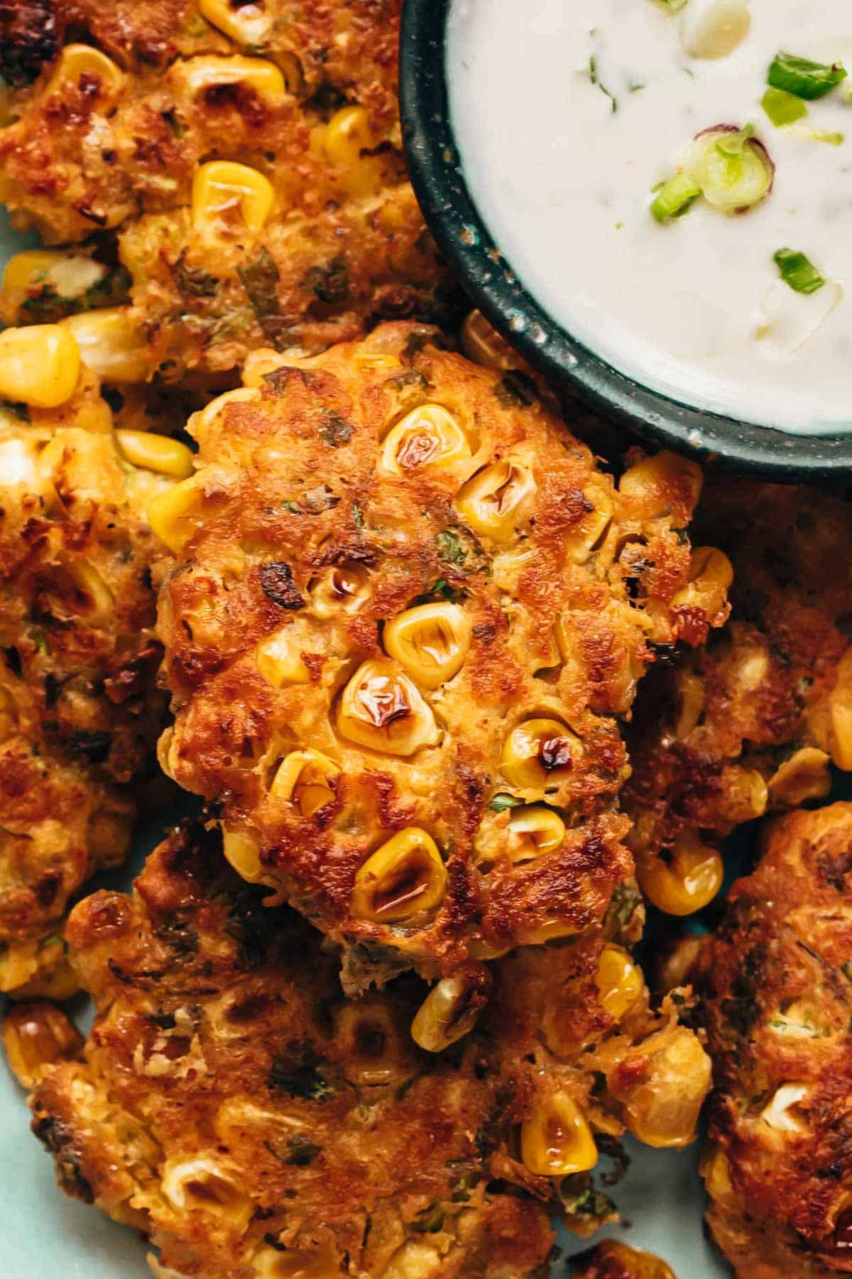 Mexican corn fritters served with a creamy dip on the side