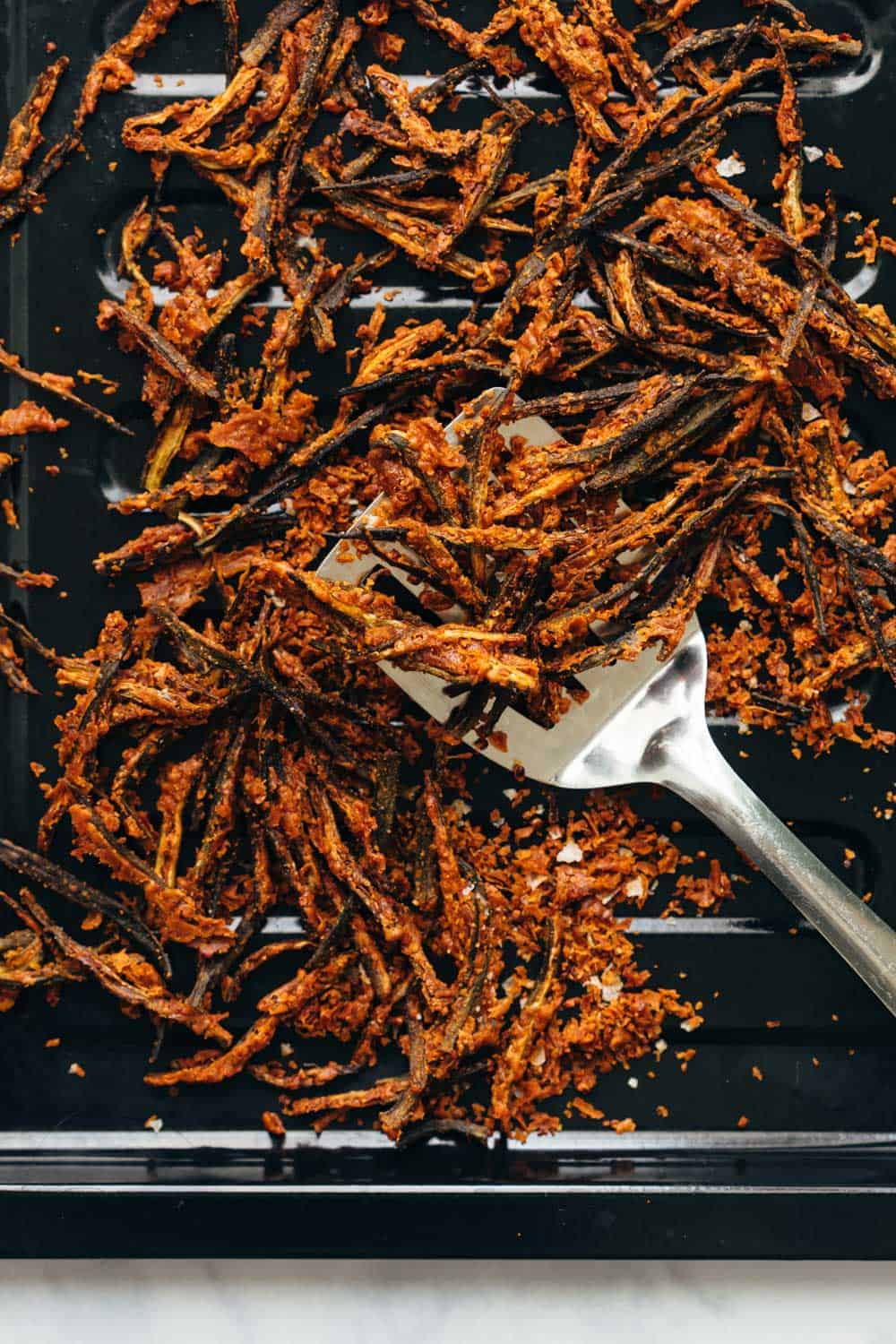 Baked kurkuri bhindi straight out of the oven on a baking tray