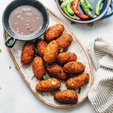Crispy veg nuggets served on a platter with sichuan sauce