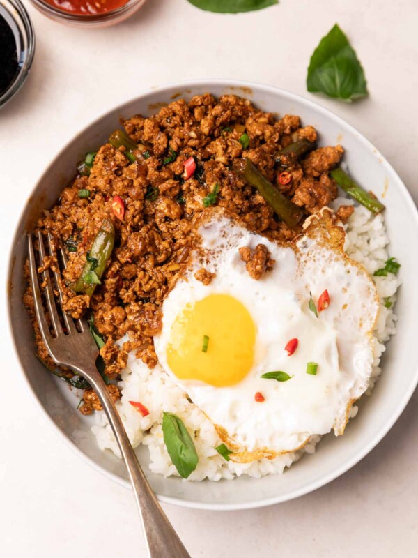thai basil chicken served with steamed rice and an egg