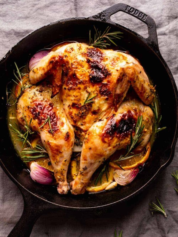 Roasted spatchcock chicken oven roasted and served in a cast iron skillet
