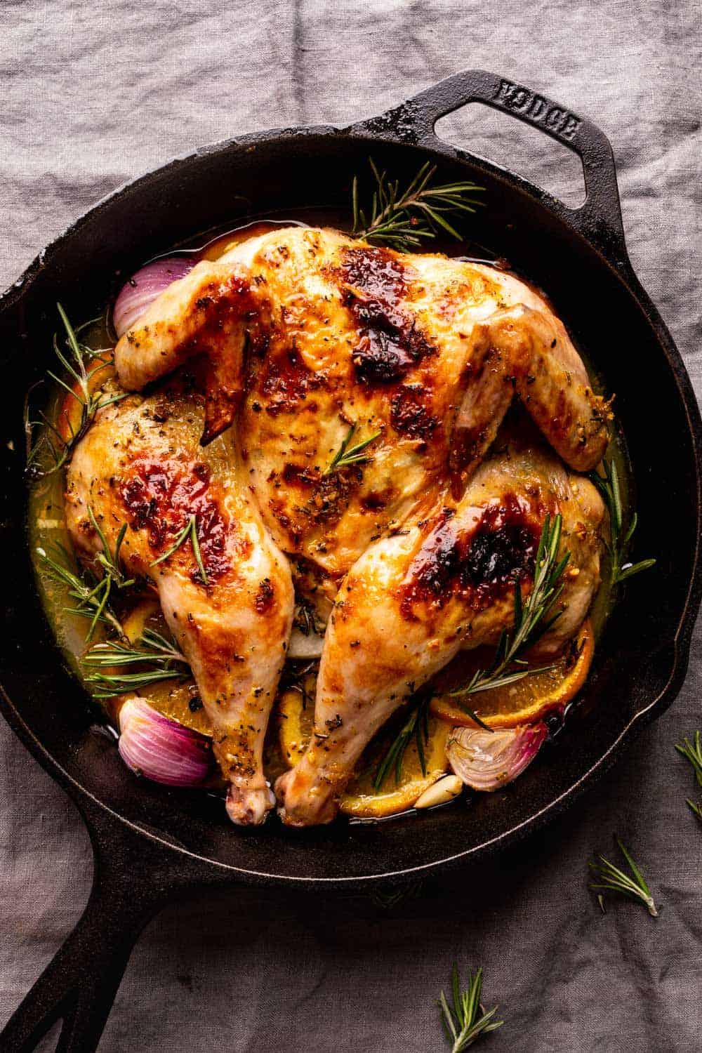 Roasted spatchcock chicken oven roasted and served in a cast iron skillet