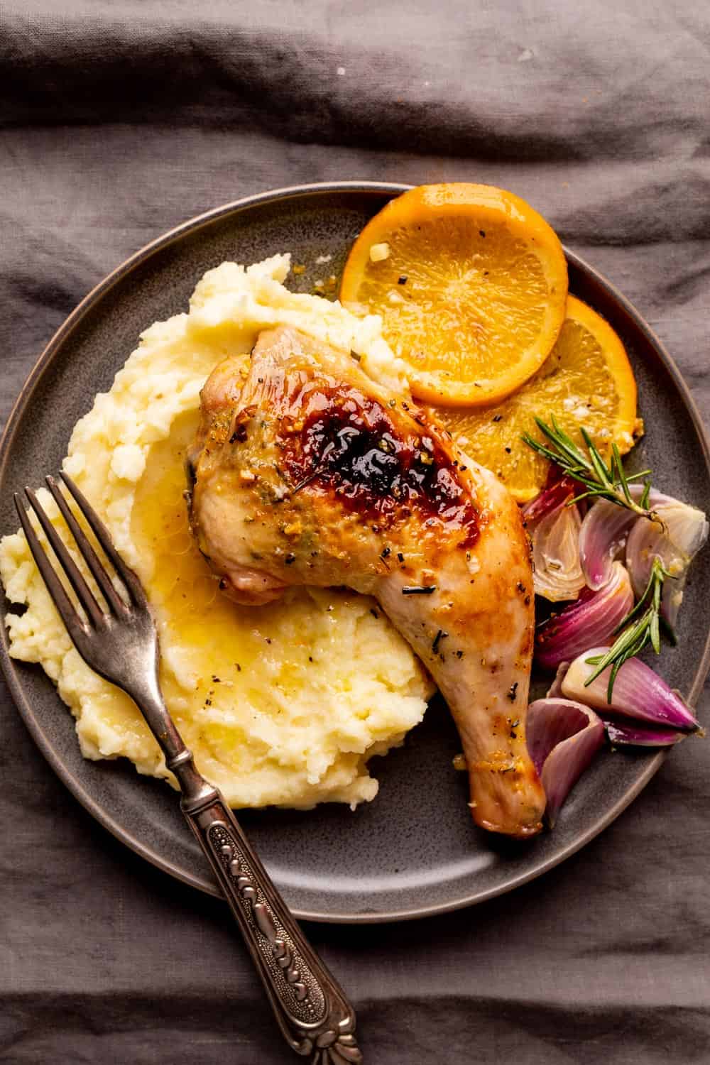 Spatchcocked chicken leg served over mashed potatoes with jus