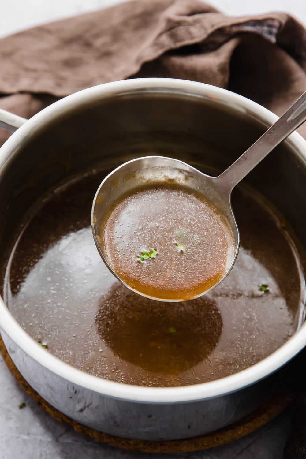 A ladle of brown vegetarian gravy