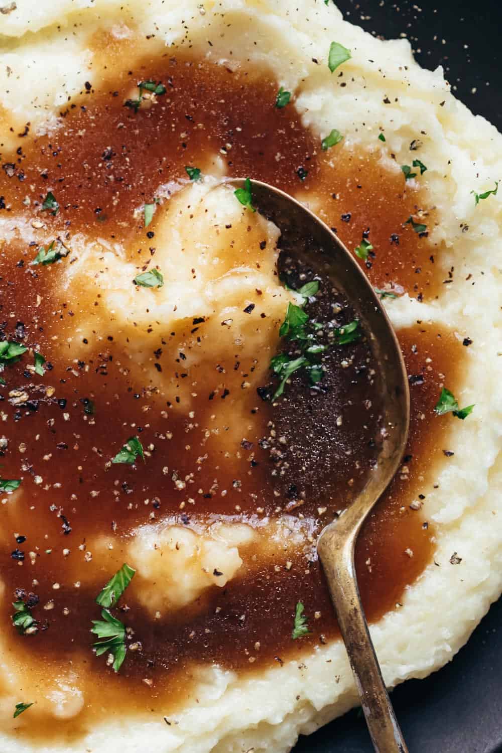Closeup of brown vegetarian gravy served over mashed potatoes