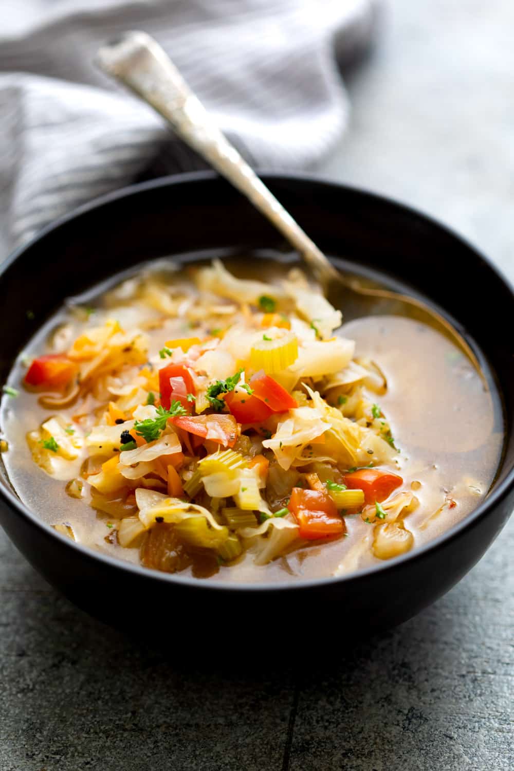 Detox cabbage soup served in a black bowl