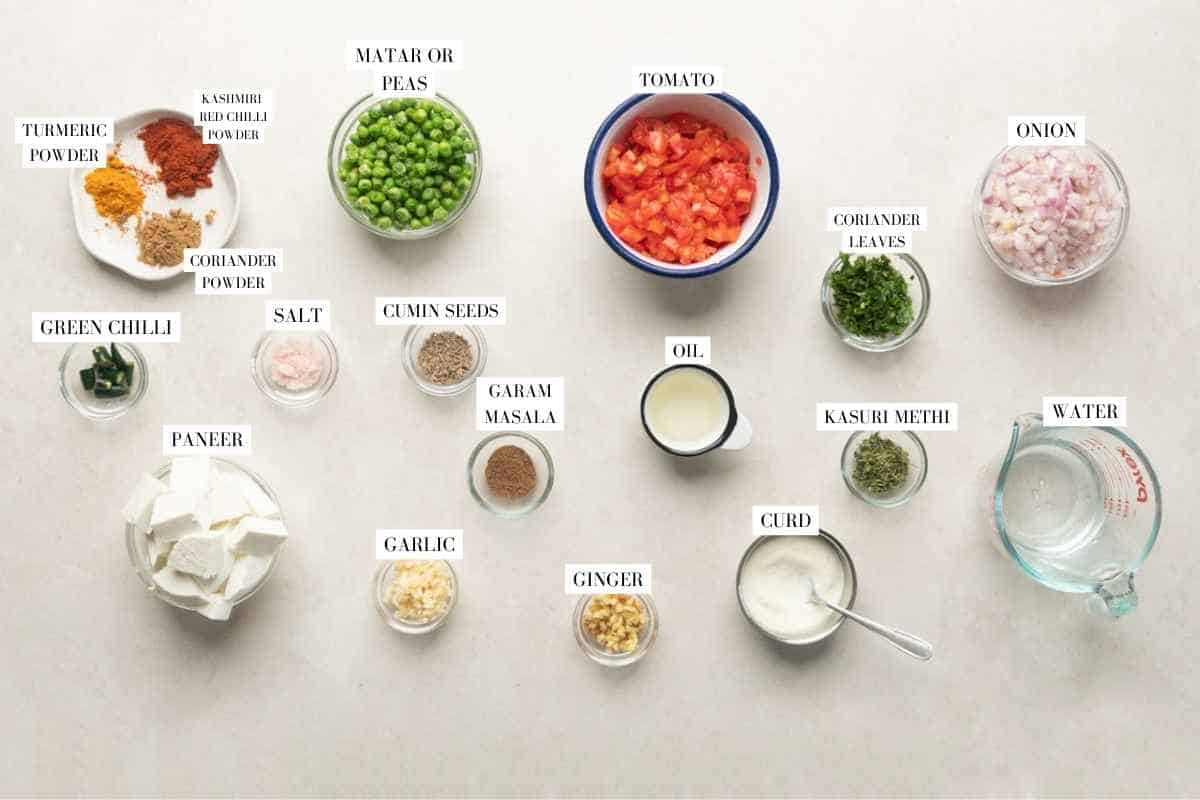 Picture of all the ingredients for matar paneer with text to identify them