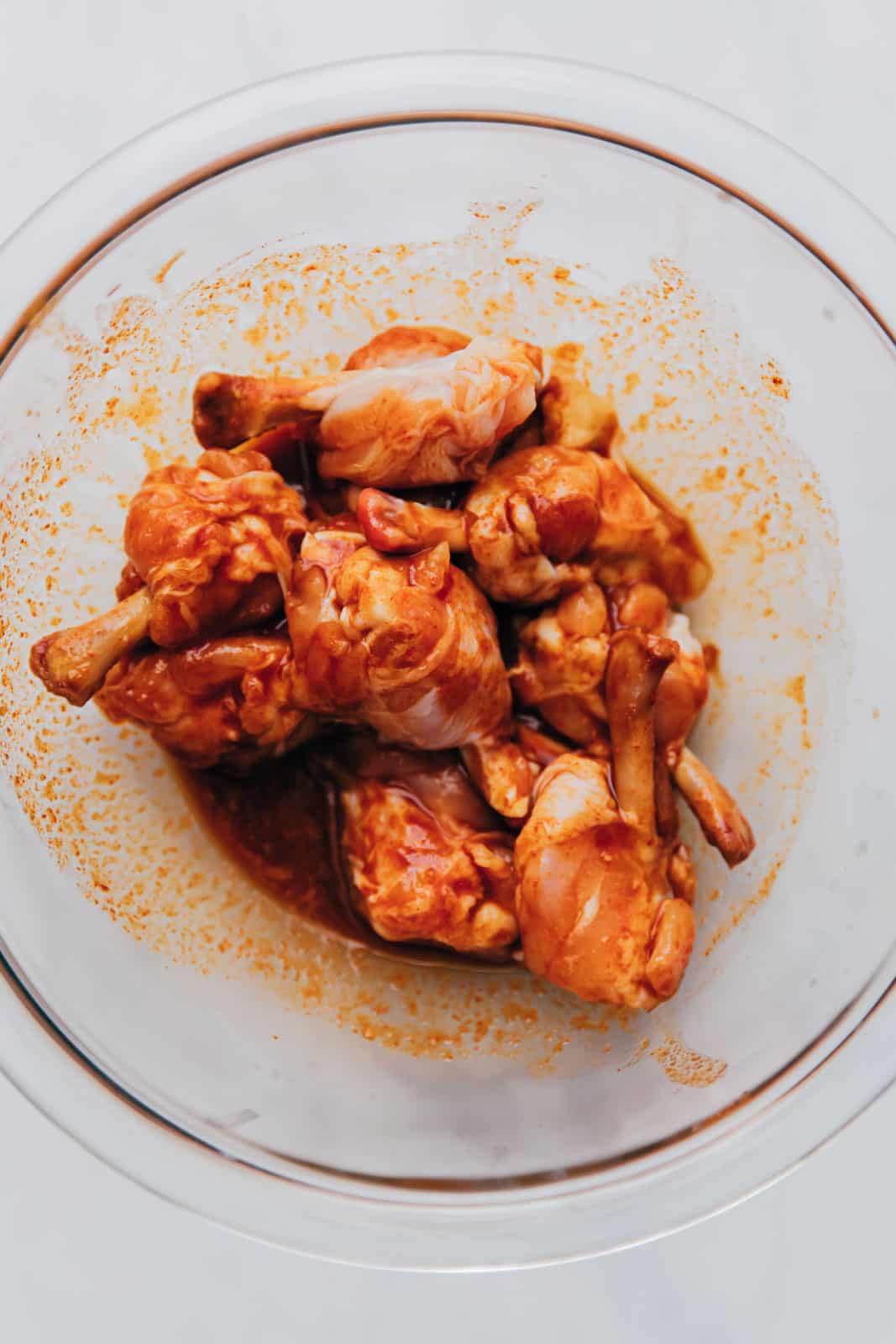 Chicken lollipop marinating in a bowl