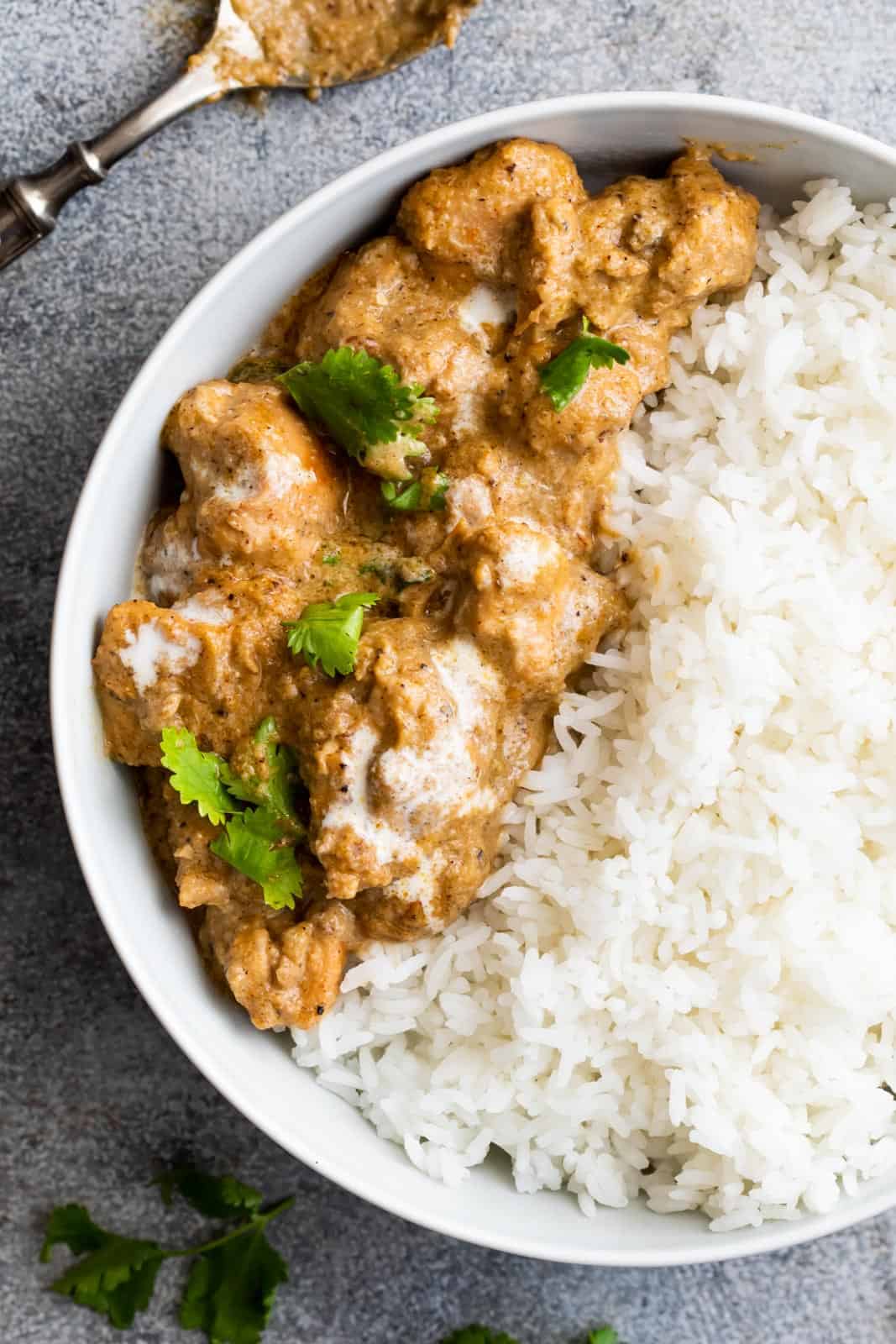 Easy chicken korma served in a bowl with rice