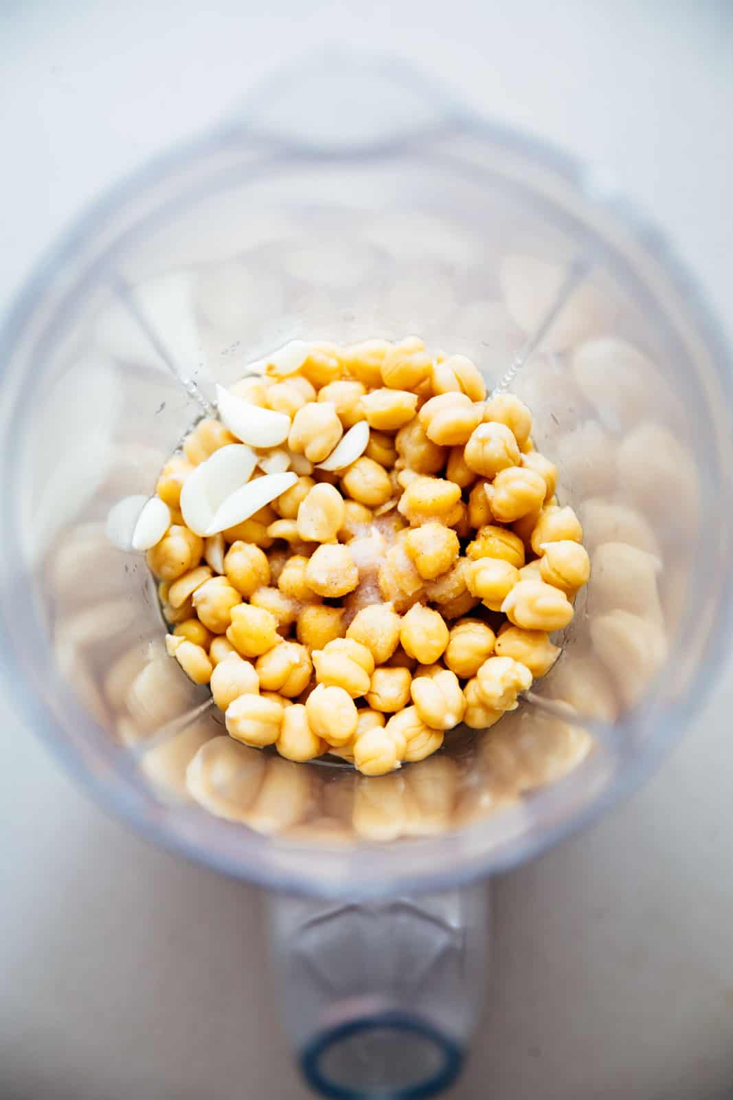 Add chickpeas, garlic, salt to a blender