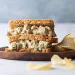 Curry Chicken salad sandwich served on a plate with potato chips