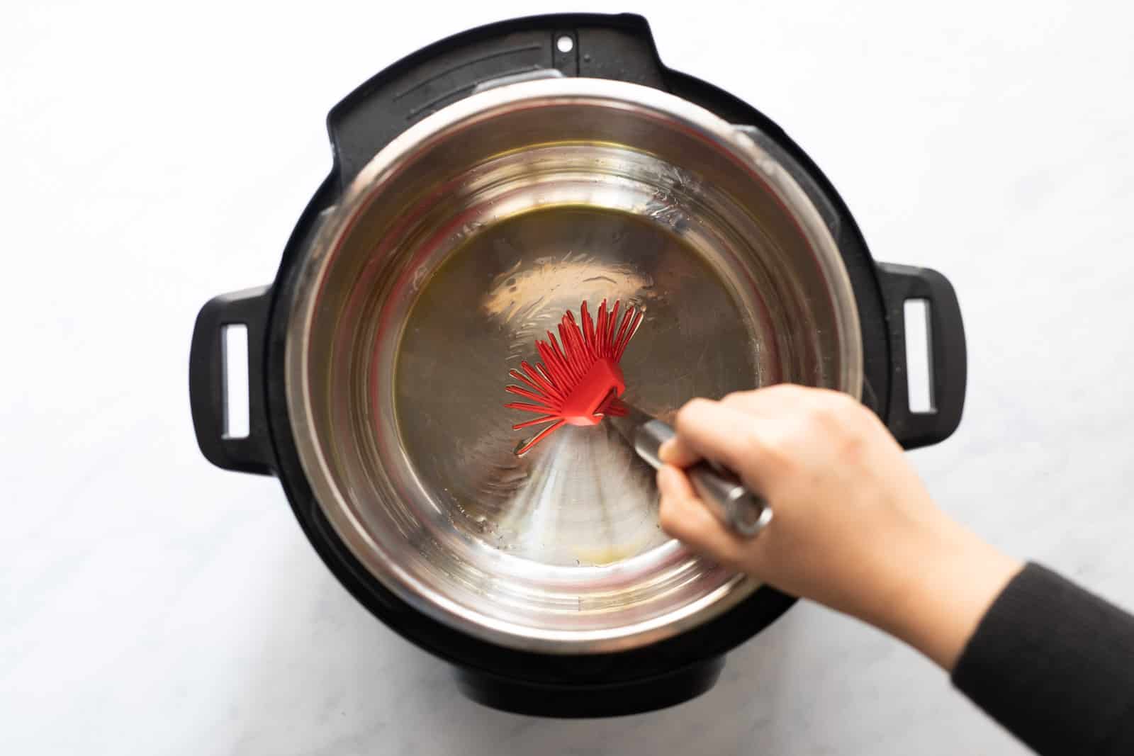 Brushing the Instant Pot steel insert with oil