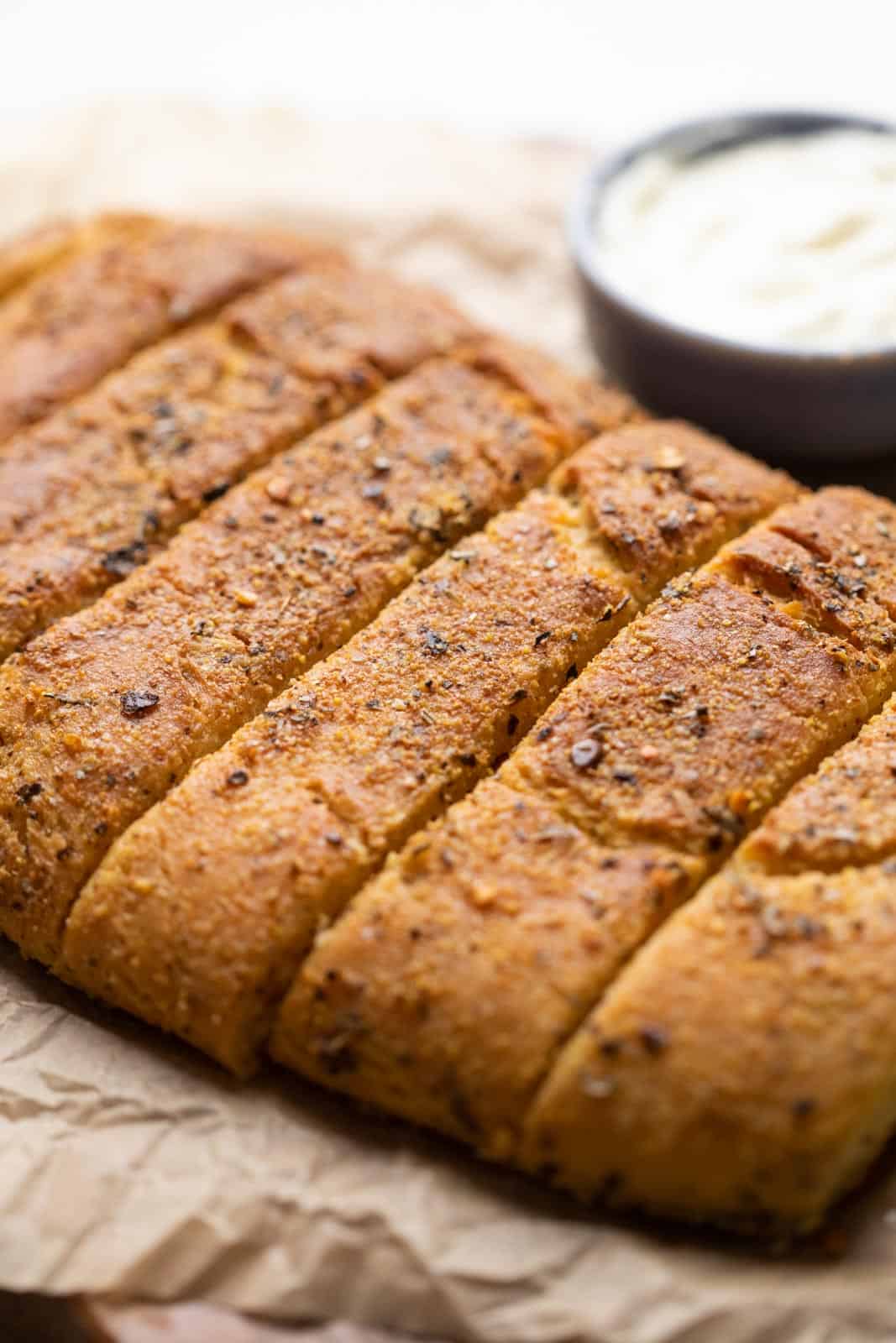 Dominos garlic breadsticks placed on parchment paper to show the crunchy crust