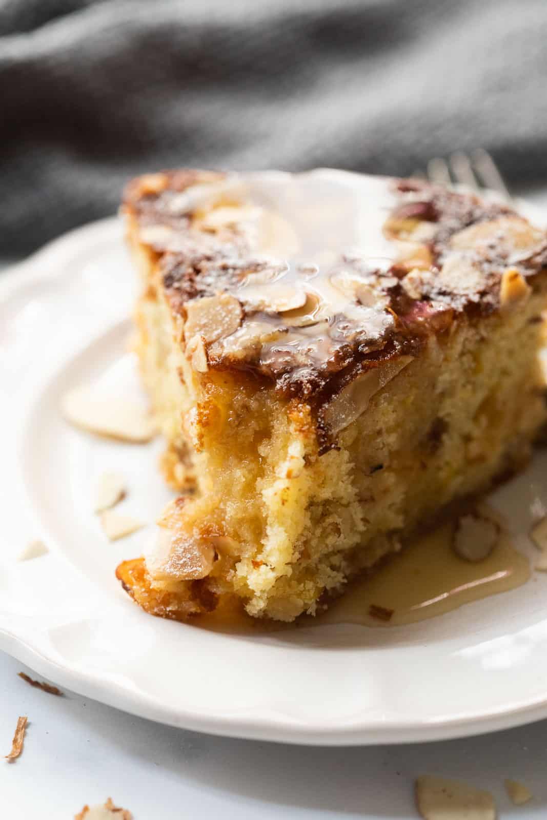 Close up of a slice of dundee cake to showcase the moist crumb