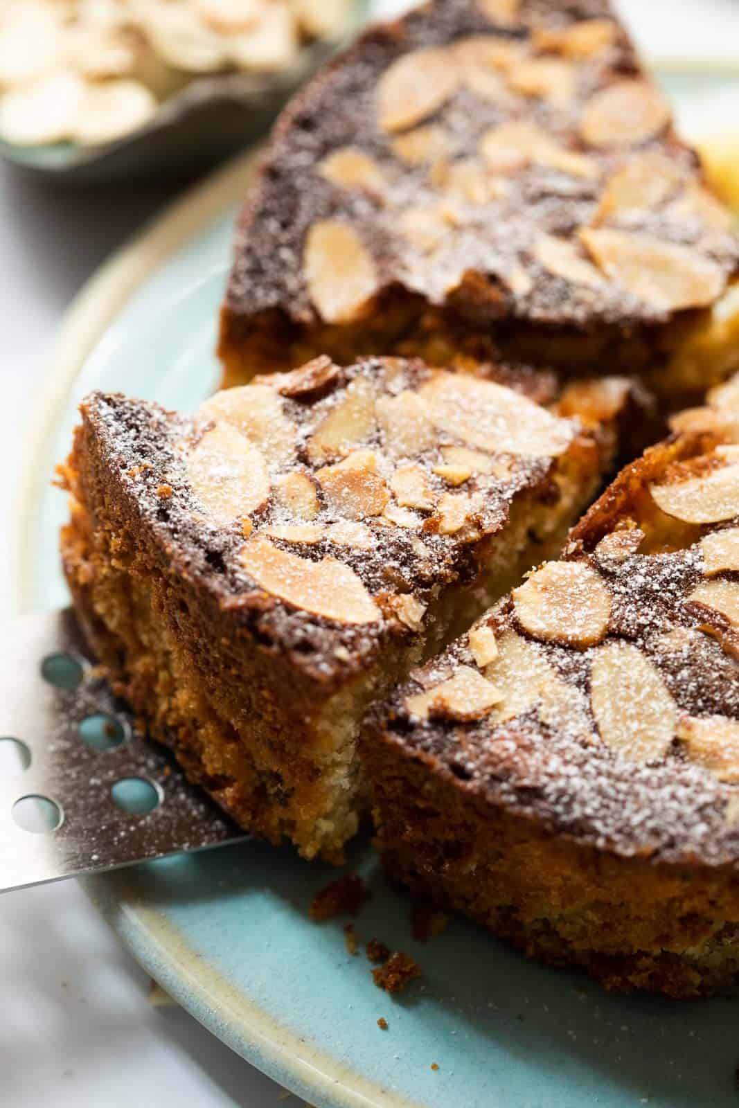 A slice of dundee cake being taken out with a cake lifter