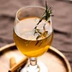 Hot toddy served in a short stemmed glass on a brown plate