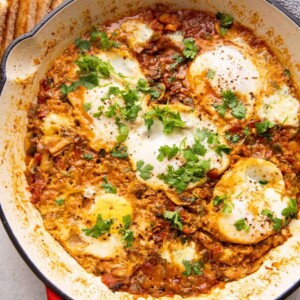 Masala shakshuka in a large pan served with toasted bread