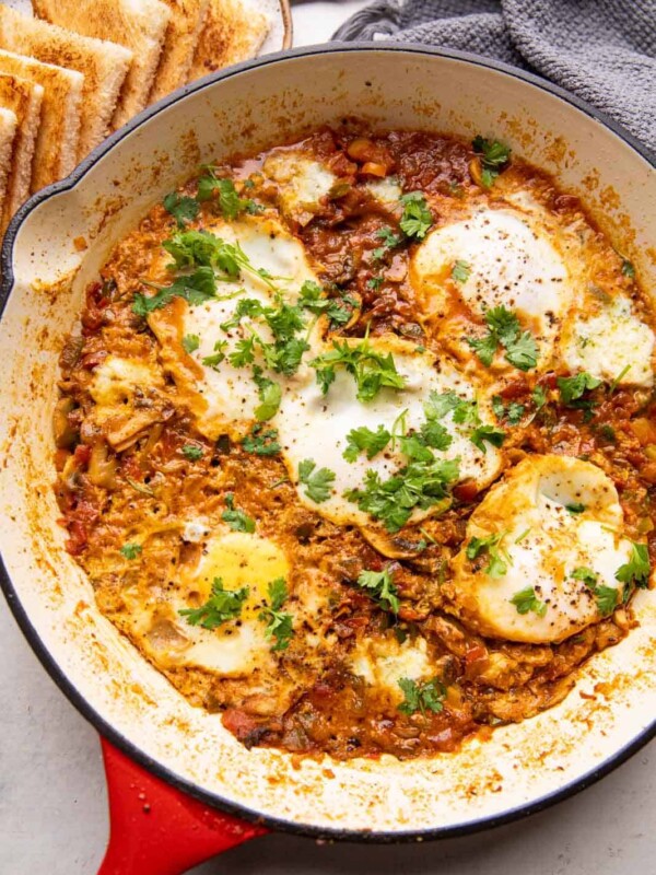 Masala shakshuka in a large pan served with toasted bread
