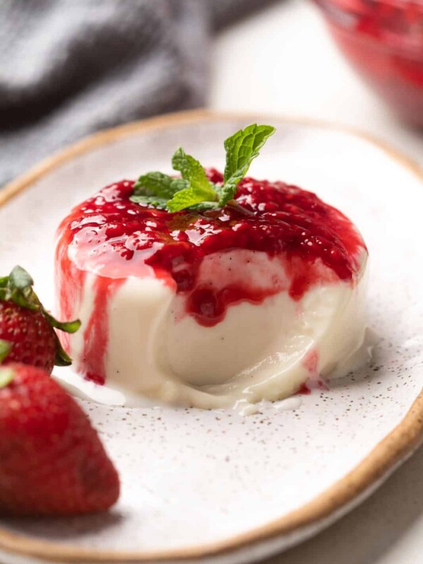 Picture of panna cotta on a plate with a bite taken out of it