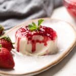 Picture of panna cotta on a plate with a bite taken out of it