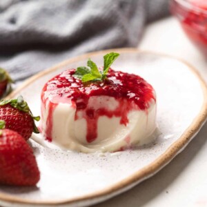 Picture of panna cotta on a plate with a bite taken out of it