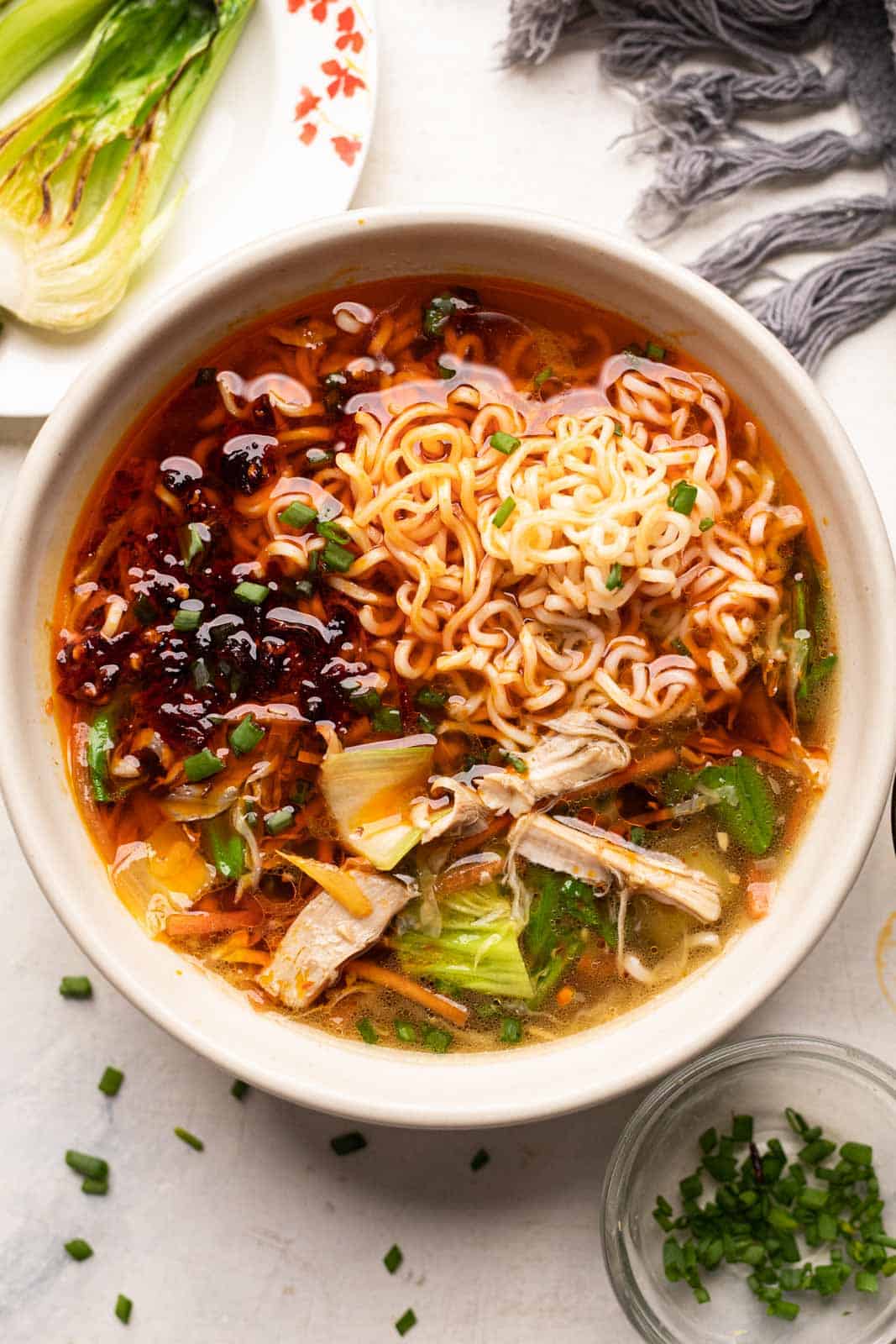 Chicken thukpa served with ramen noodles, veggies and some bok choy and spring onions on the side