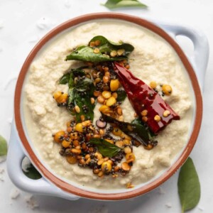 Coconut Chutney served in a light blue bowl with tempering on top