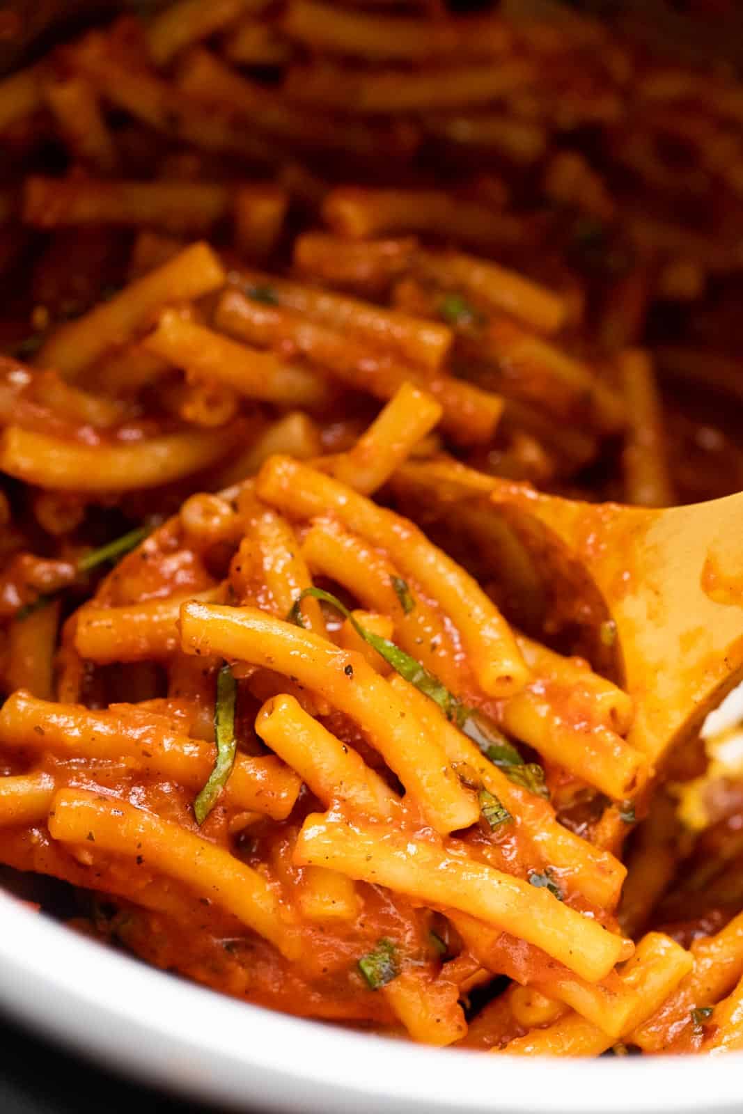 Closeup of pasta being scooped up in a ladle in the instant pot