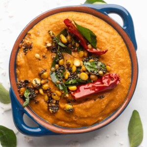 Tomato Chutney served in a blue bowl with tempering on top