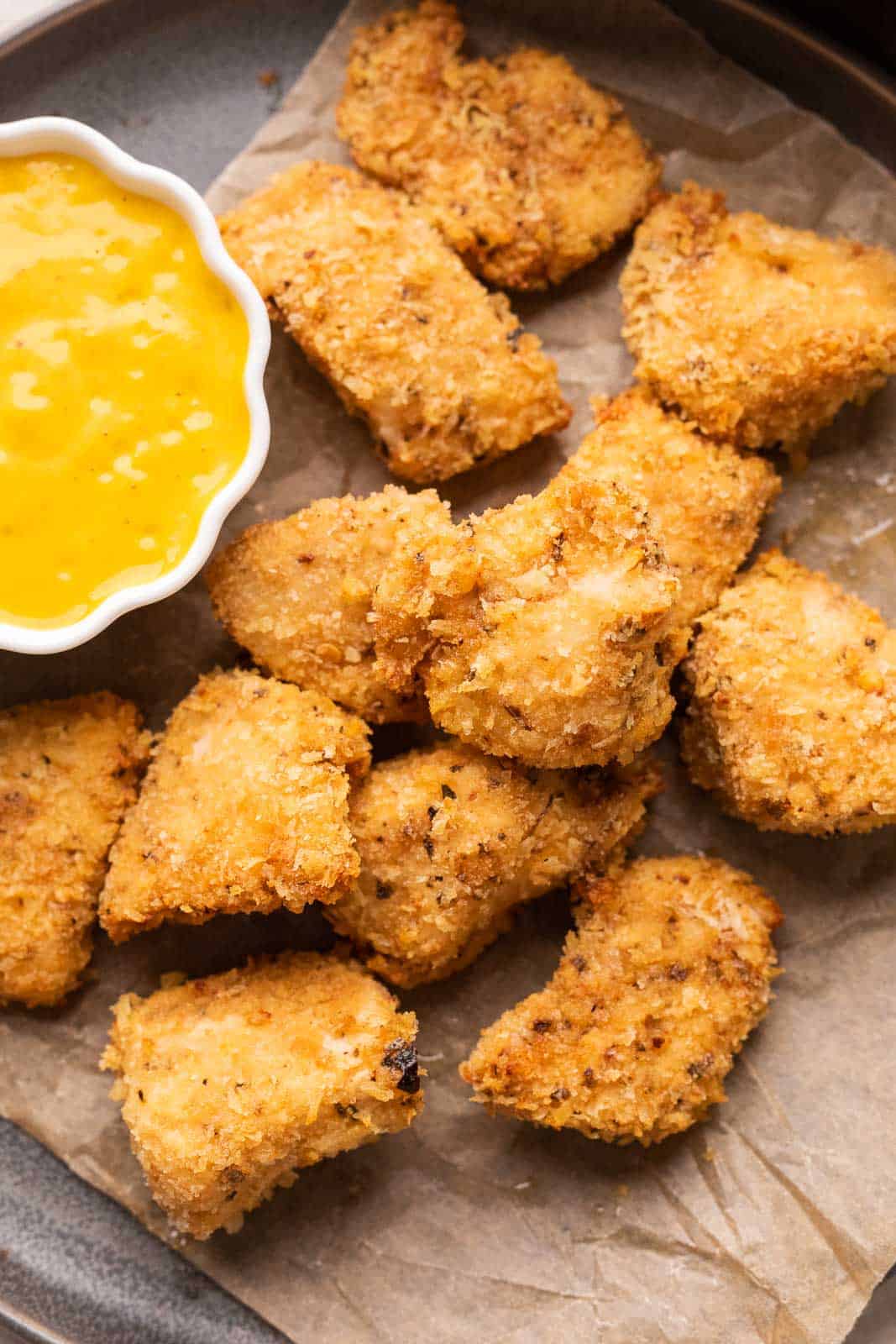 Chicken Nuggets served on a plate with a mango mustard dipping sauce