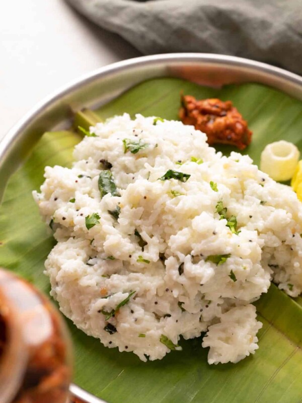 Curd rice served on a plate with pickle and fryums