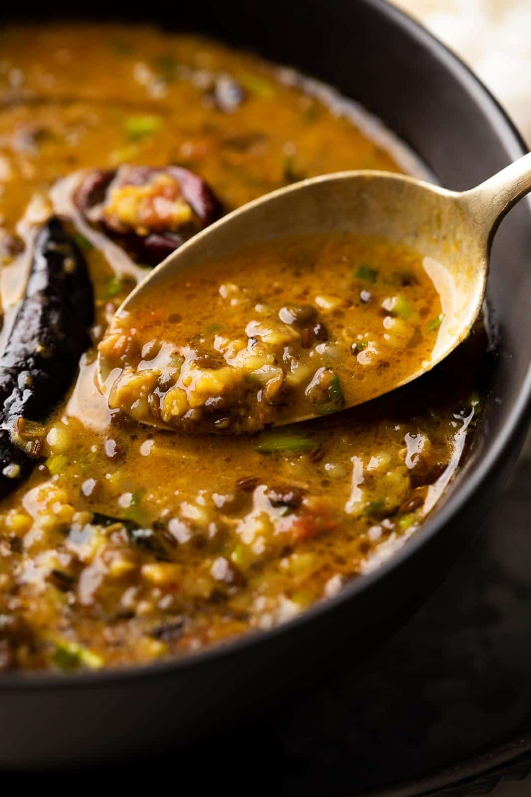 Closeup of a spoonful of Dhaba style moong dal to show the texture and creaminess