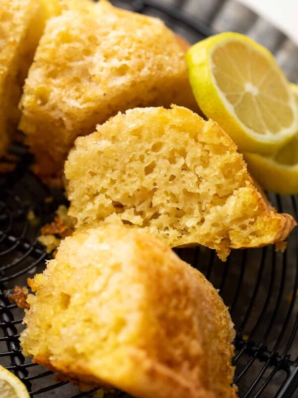 A slice of eggless lemon cake to show the light airy texture of the cake