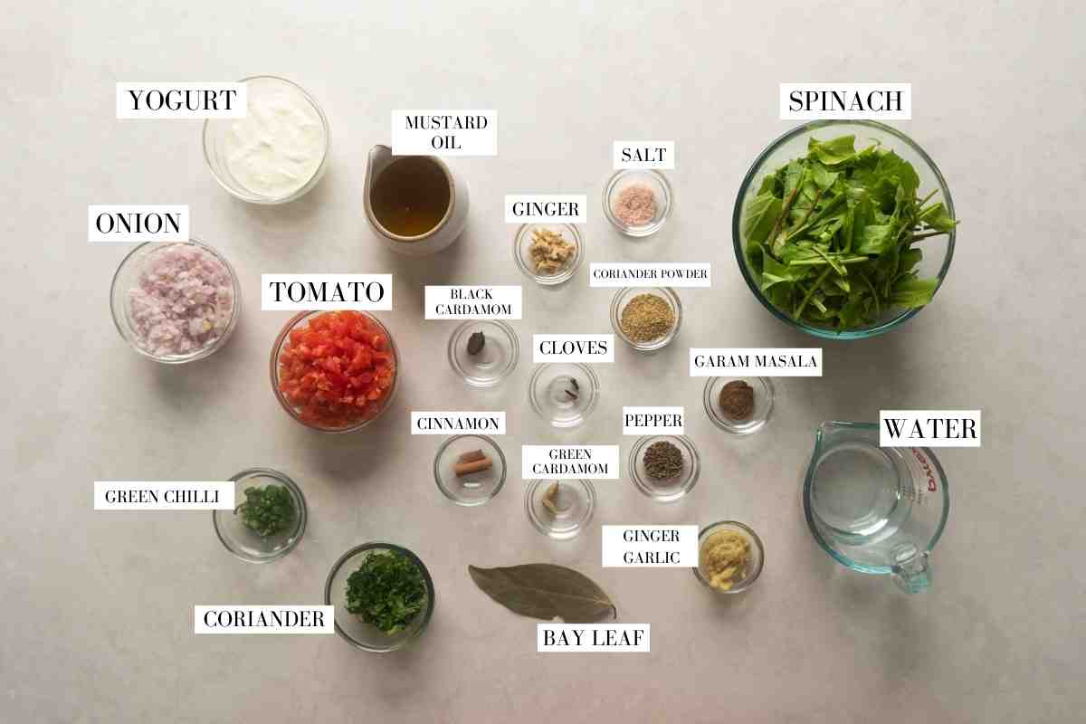 Ingredients for saag chicken curry pictured together with text to identify them