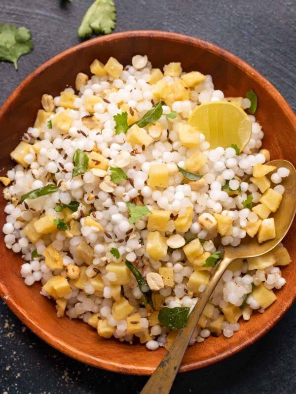 Sabudana khichdi served in a brown bowl with a spoon