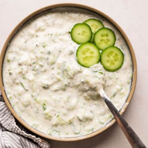 Cucumber Raita served in a bowl with sliced cucumber as garnish