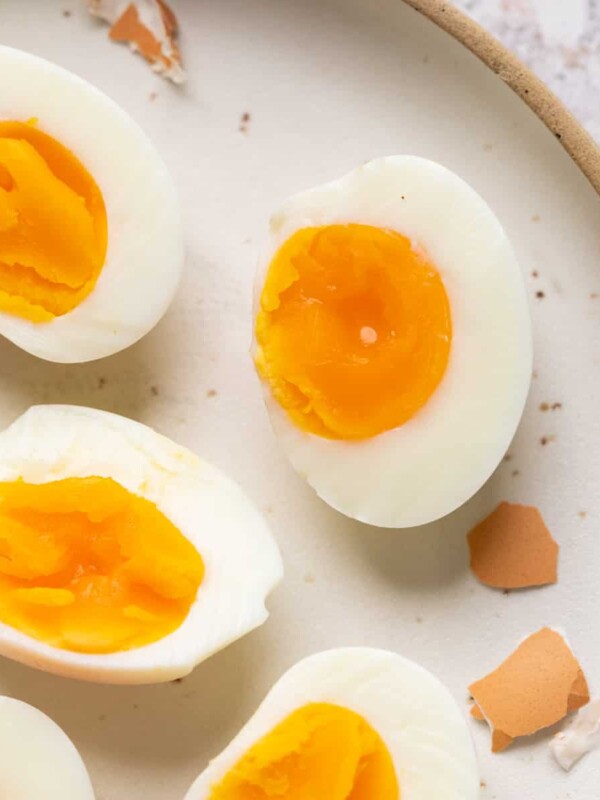 Different varieties of hard boiled eggs placed on a white plate
