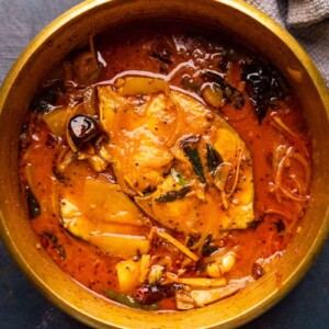 Raw Mango Fish Curry served in a brass pot that it was cooked in