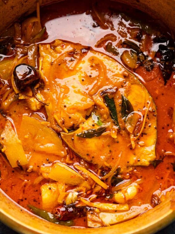 Raw Mango Fish Curry served in a brass pot that it was cooked in
