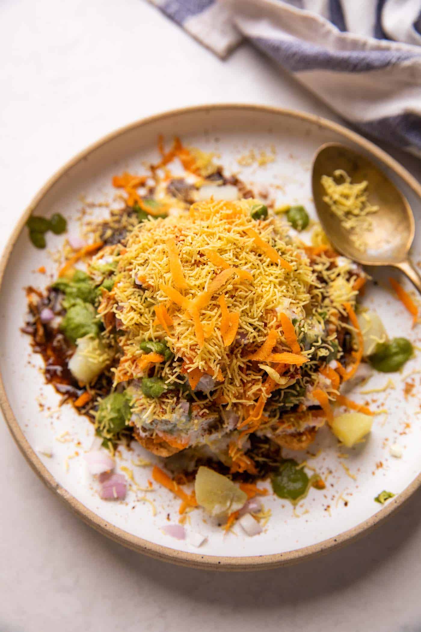 Bread Chaat served on a white plate with a spoon on the side