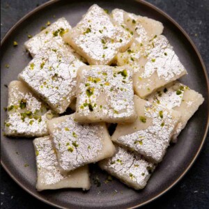 Coconut barfi served on a grey plate