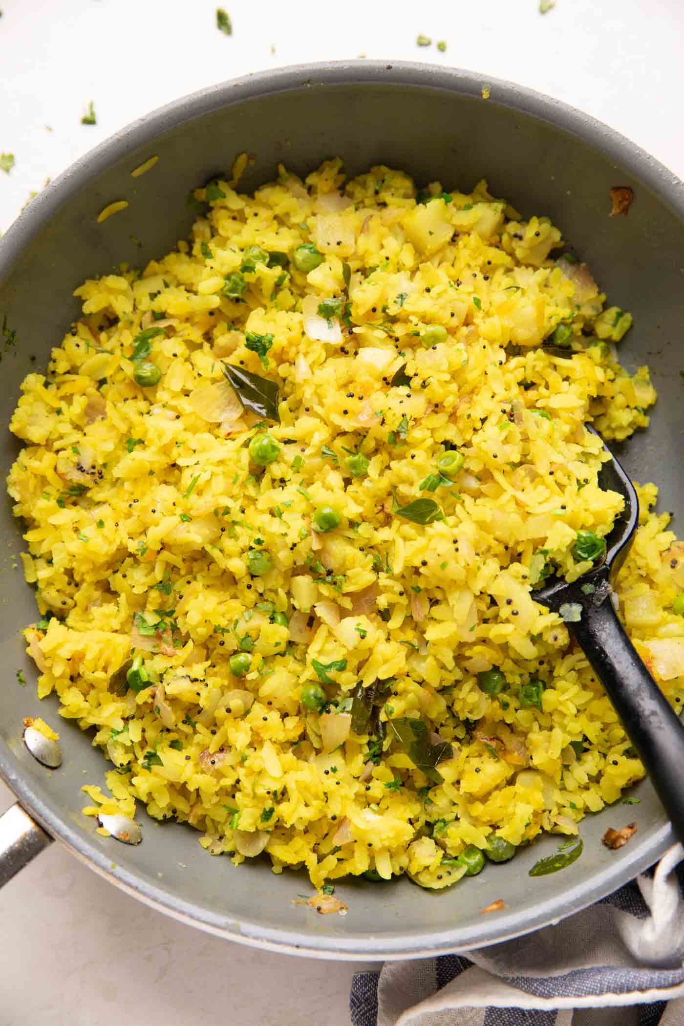 kanda batata poha in a pan